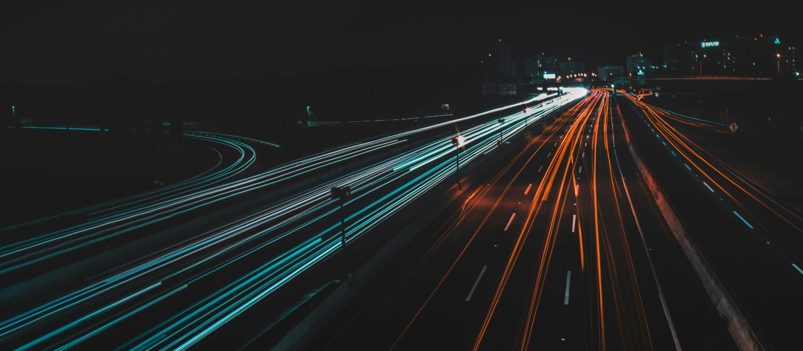 Long-exposure light trails from traffic on a motorway at night